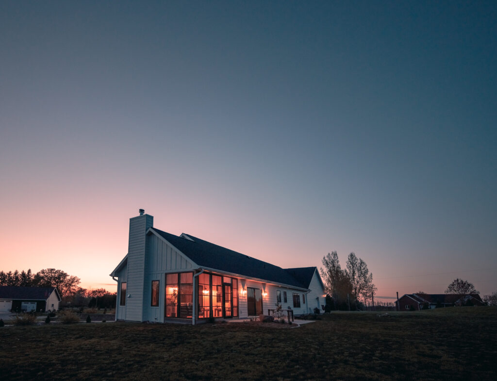 A porch enclosure glowing at dusk
