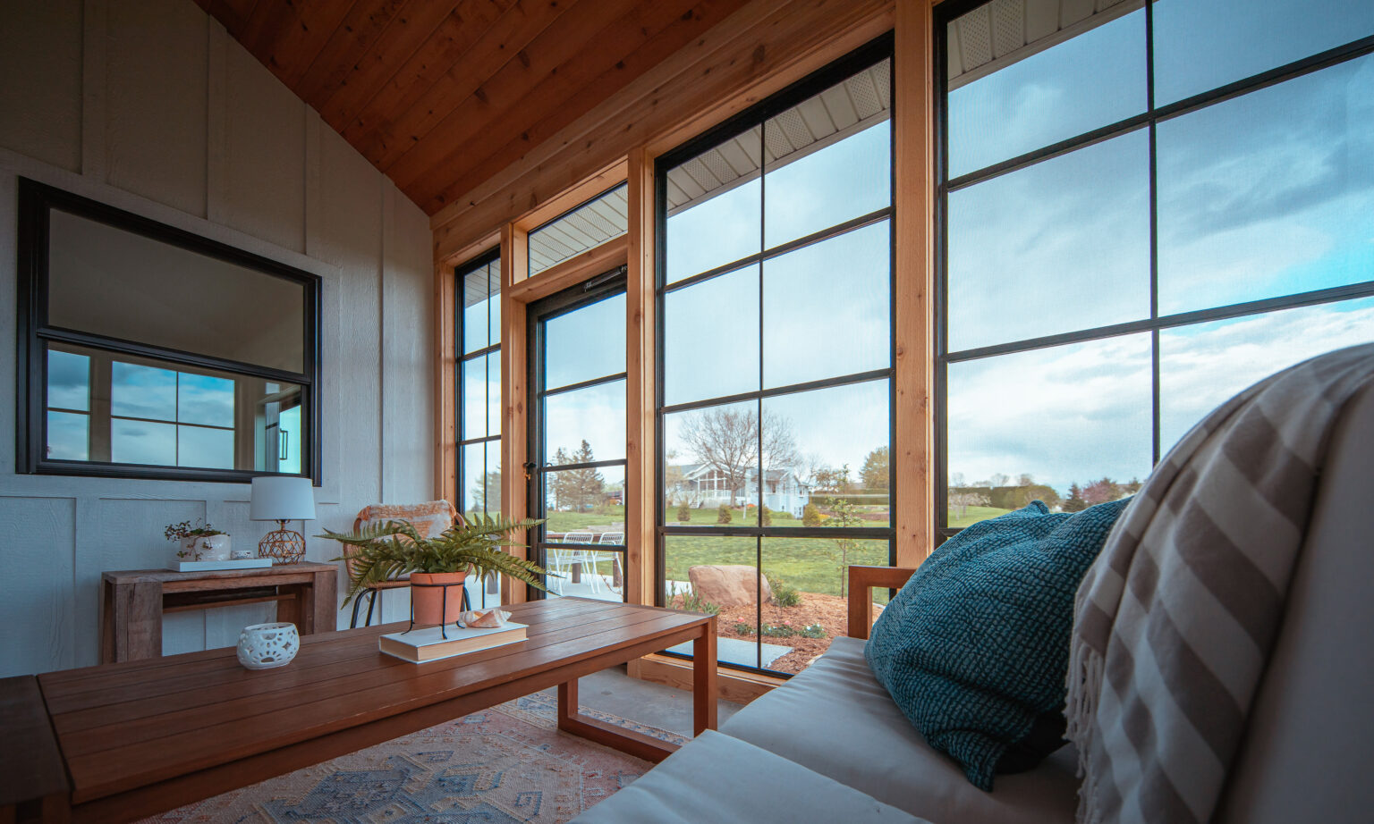 Inside the Andersons porch, enclosed with black-frame vertical sliders