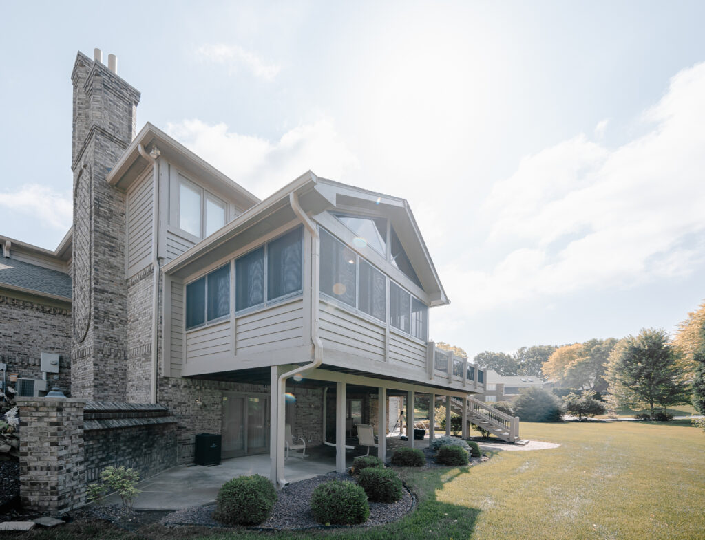 Exterior of a two-story home with an enclosed upper deck