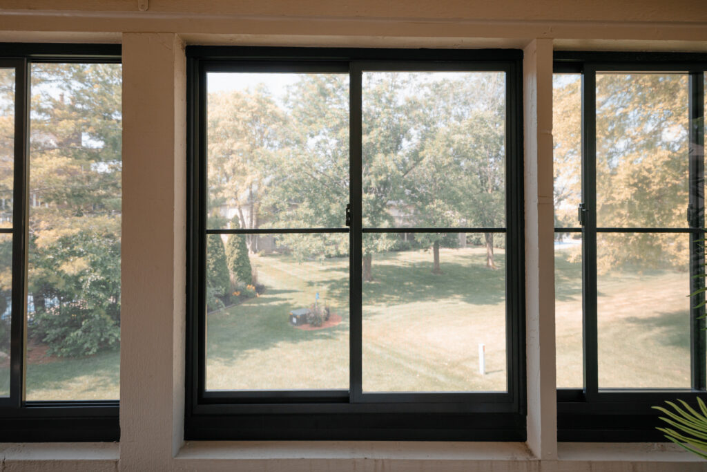 Black-frame horizontal slider windows on the Beranek porch enclosure
